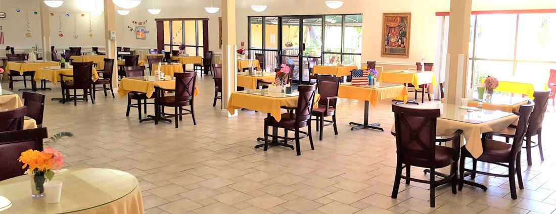 Dining room at Sunny Hills in Homestead with rows of tables and chairs set for a meal