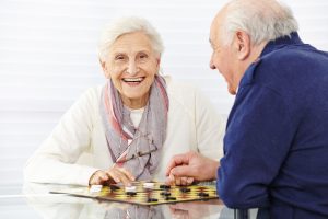 seniors in assisted living facility playing checkers